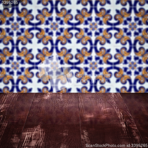 Image of Wood table top and blur vintage ceramic tile pattern wall