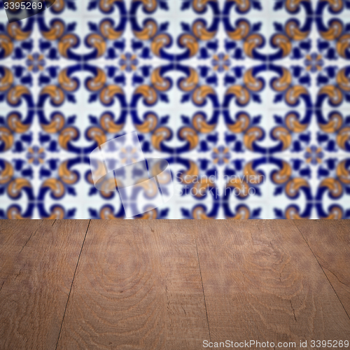 Image of Wood table top and blur vintage ceramic tile pattern wall