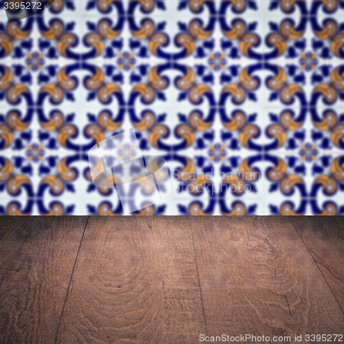 Image of Wood table top and blur vintage ceramic tile pattern wall