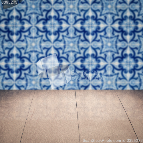 Image of Wood table top and blur vintage ceramic tile pattern wall