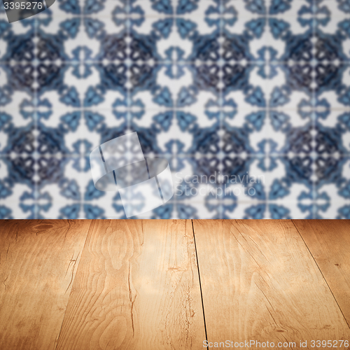 Image of Wood table top and blur vintage ceramic tile pattern wall