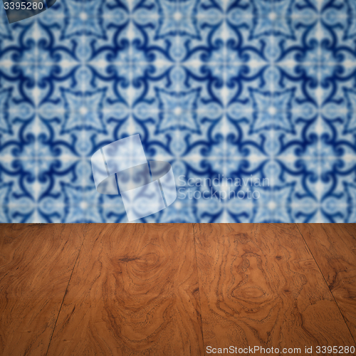 Image of Wood table top and blur vintage ceramic tile pattern wall