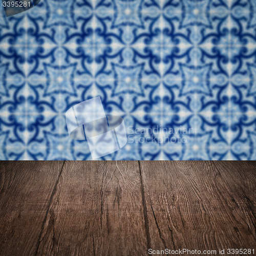 Image of Wood table top and blur vintage ceramic tile pattern wall