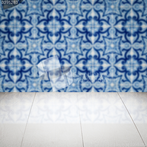 Image of Wood table top and blur vintage ceramic tile pattern wall