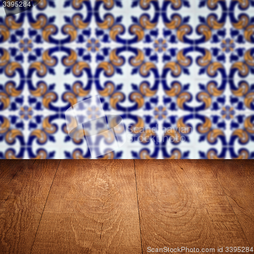 Image of Wood table top and blur vintage ceramic tile pattern wall