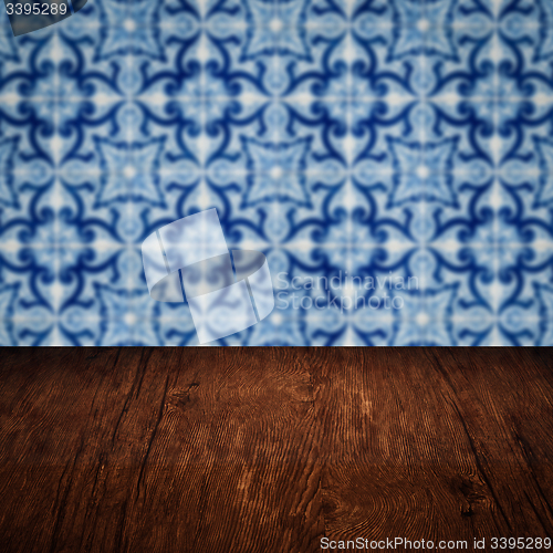 Image of Wood table top and blur vintage ceramic tile pattern wall
