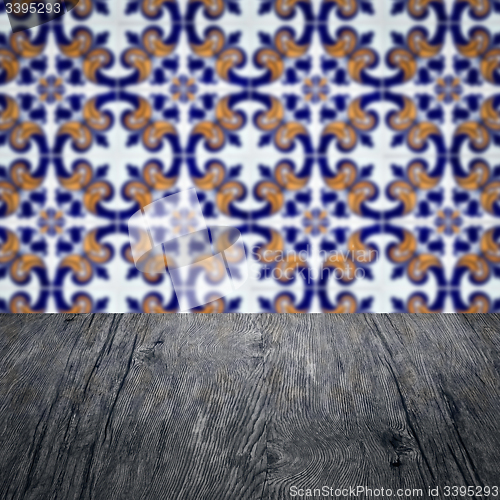 Image of Wood table top and blur vintage ceramic tile pattern wall