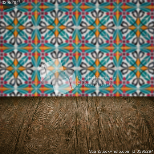 Image of Wood table top and blur vintage ceramic tile pattern wall