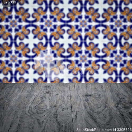 Image of Wood table top and blur vintage ceramic tile pattern wall