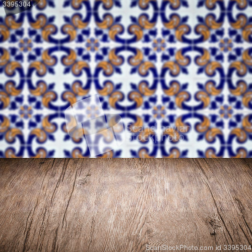 Image of Wood table top and blur vintage ceramic tile pattern wall