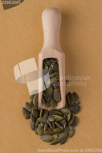 Image of Wooden scoop with pumpkin seeds