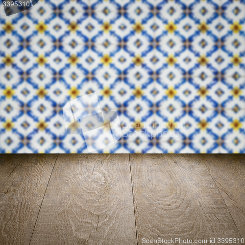 Image of Wood table top and blur vintage ceramic tile pattern wall