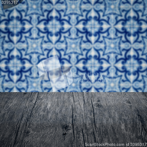 Image of Wood table top and blur vintage ceramic tile pattern wall