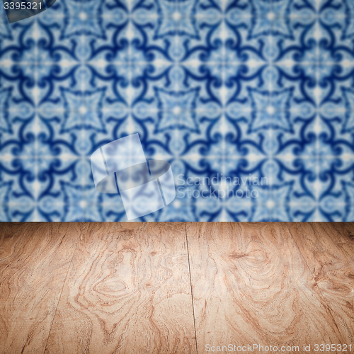 Image of Wood table top and blur vintage ceramic tile pattern wall