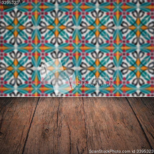 Image of Wood table top and blur vintage ceramic tile pattern wall