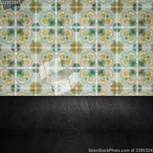 Image of Wood table top and blur vintage ceramic tile pattern wall