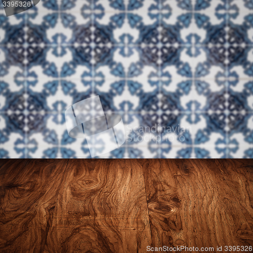 Image of Wood table top and blur vintage ceramic tile pattern wall