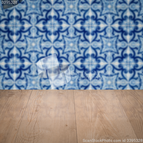 Image of Wood table top and blur vintage ceramic tile pattern wall