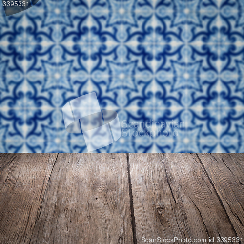 Image of Wood table top and blur vintage ceramic tile pattern wall