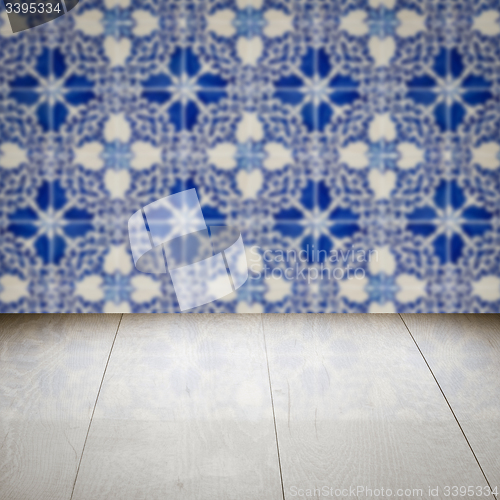 Image of Wood table top and blur vintage ceramic tile pattern wall
