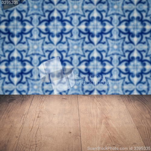 Image of Wood table top and blur vintage ceramic tile pattern wall