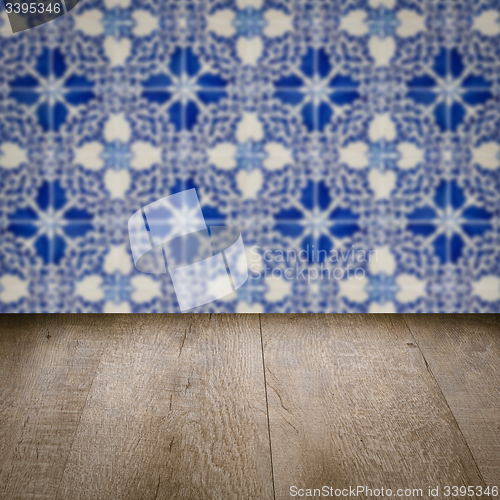 Image of Wood table top and blur vintage ceramic tile pattern wall