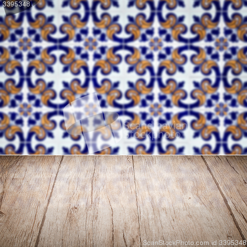 Image of Wood table top and blur vintage ceramic tile pattern wall