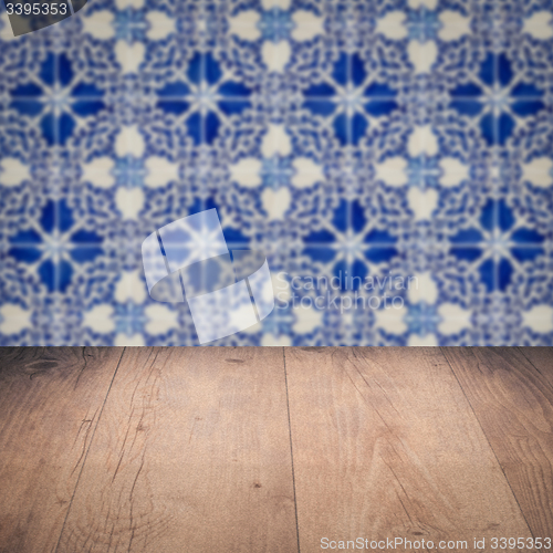 Image of Wood table top and blur vintage ceramic tile pattern wall