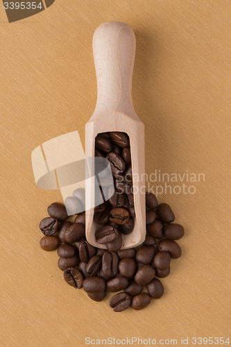 Image of Wooden scoop with coffee beans