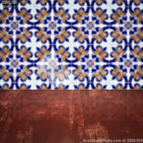 Image of Wood table top and blur vintage ceramic tile pattern wall