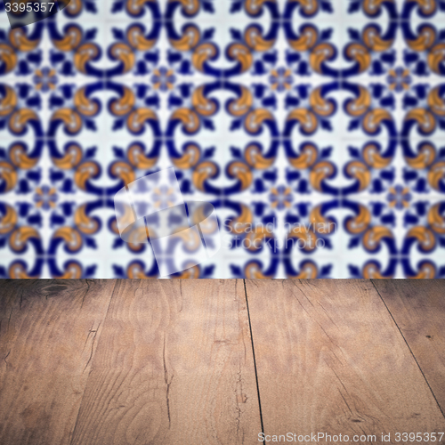 Image of Wood table top and blur vintage ceramic tile pattern wall