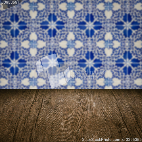 Image of Wood table top and blur vintage ceramic tile pattern wall