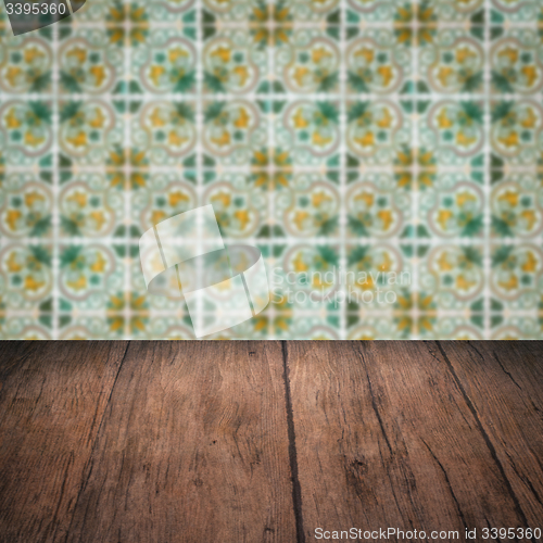 Image of Wood table top and blur vintage ceramic tile pattern wall