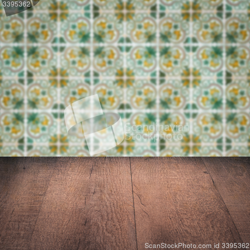Image of Wood table top and blur vintage ceramic tile pattern wall