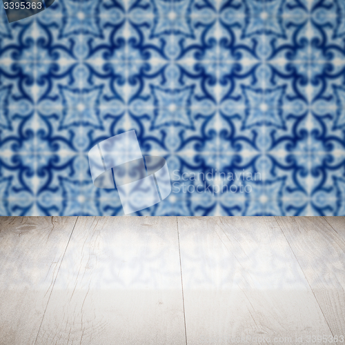 Image of Wood table top and blur vintage ceramic tile pattern wall
