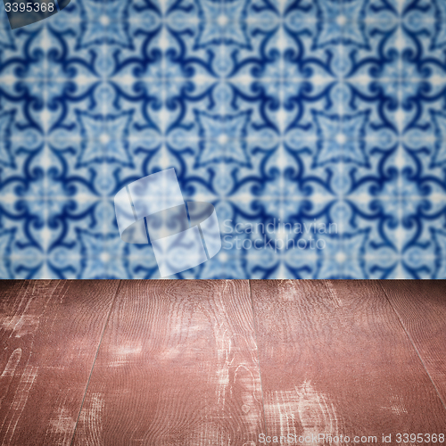 Image of Wood table top and blur vintage ceramic tile pattern wall