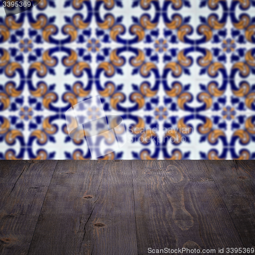 Image of Wood table top and blur vintage ceramic tile pattern wall