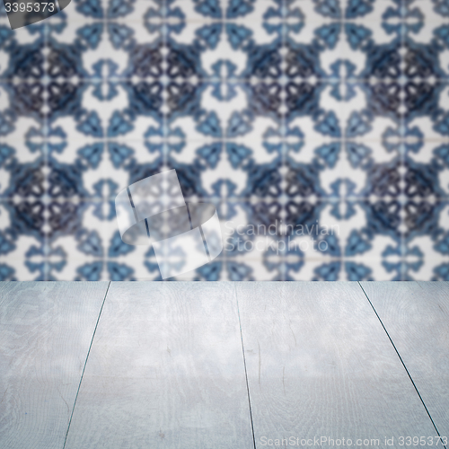 Image of Wood table top and blur vintage ceramic tile pattern wall