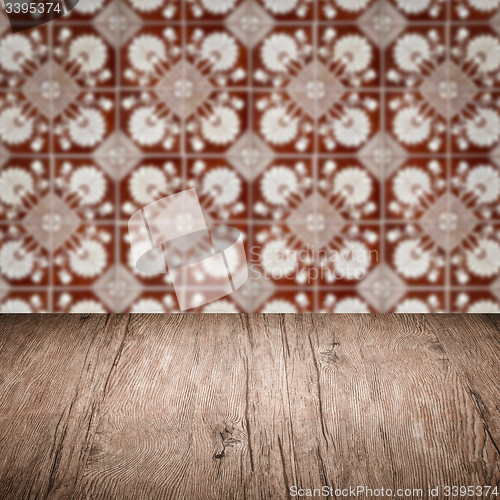 Image of Wood table top and blur vintage ceramic tile pattern wall