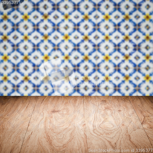 Image of Wood table top and blur vintage ceramic tile pattern wall