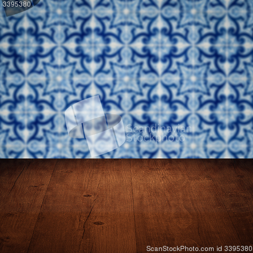 Image of Wood table top and blur vintage ceramic tile pattern wall