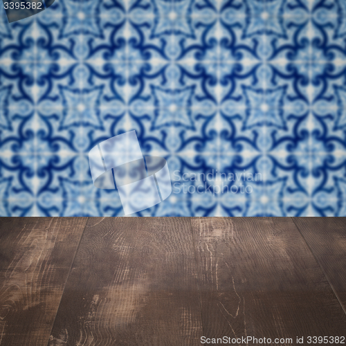 Image of Wood table top and blur vintage ceramic tile pattern wall