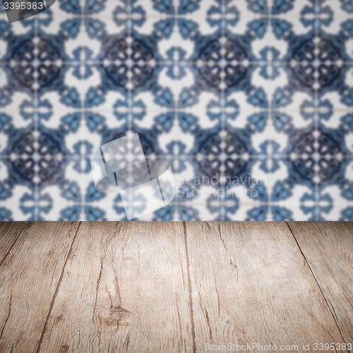 Image of Wood table top and blur vintage ceramic tile pattern wall