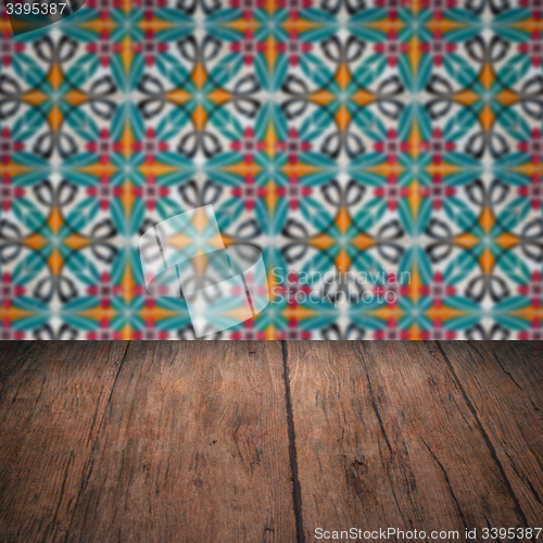 Image of Wood table top and blur vintage ceramic tile pattern wall