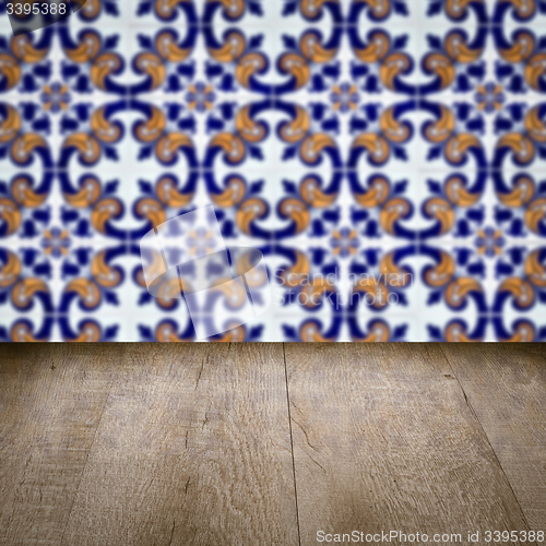 Image of Wood table top and blur vintage ceramic tile pattern wall