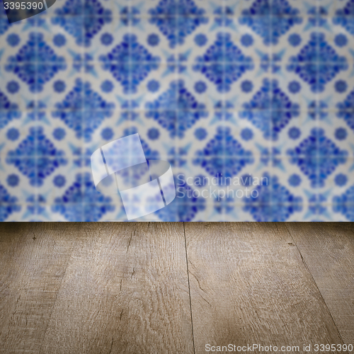 Image of Wood table top and blur vintage ceramic tile pattern wall