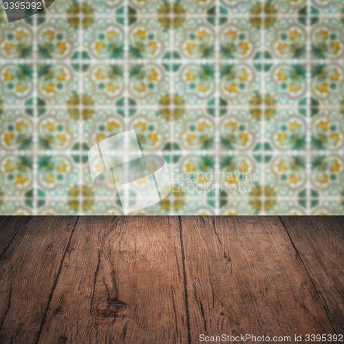 Image of Wood table top and blur vintage ceramic tile pattern wall