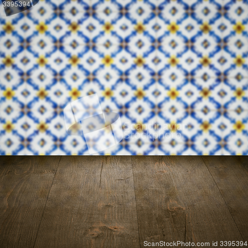 Image of Wood table top and blur vintage ceramic tile pattern wall