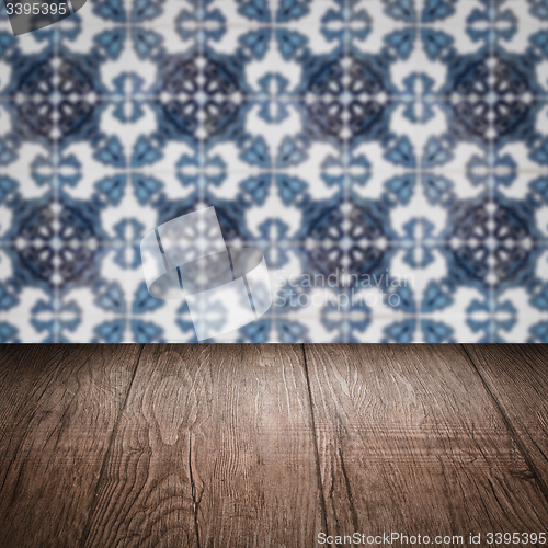 Image of Wood table top and blur vintage ceramic tile pattern wall