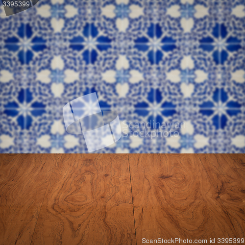 Image of Wood table top and blur vintage ceramic tile pattern wall